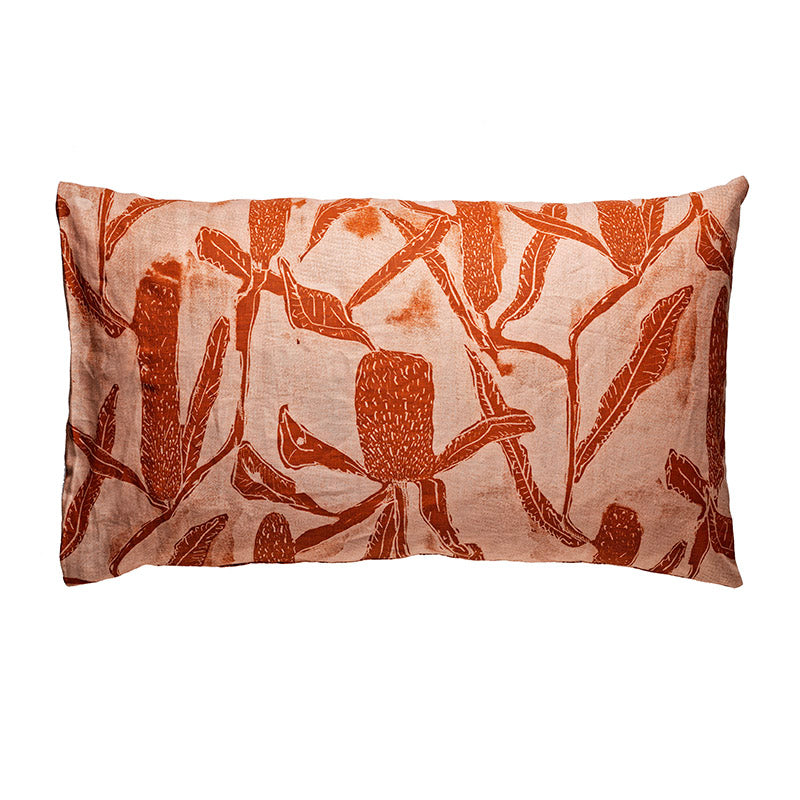 Peach pillowcase with terracotta coloured banksia pattern